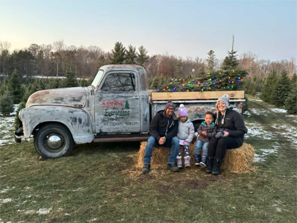 Family next to old truck.